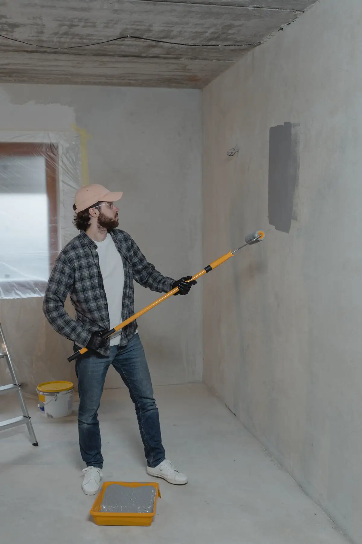 Illustrative photo of a paint roller on a yellow wall. Not a Crestline job.